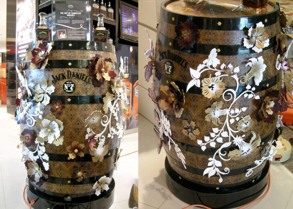 White decorative graphics applied to cylindrical retail display surfaces